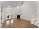 Bright living room with hardwood floors, fireplace, and natural light from the French doors at 1426 Quarter Pt, Raleigh, NC 27615