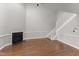 Living room featuring hardwood floors, fireplace, and carpeted staircase at 1426 Quarter Pt, Raleigh, NC 27615
