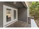 Covered outdoor patio with gray siding and sliding glass doors at 1426 Quarter Pt, Raleigh, NC 27615