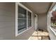 Covered porch featuring gray siding, white trim, and windows at 1426 Quarter Pt, Raleigh, NC 27615