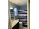 Upstairs bathroom featuring blue walls, vinyl flooring, and a standard tub and shower at 144 Gremar Dr, Holly Springs, NC 27540