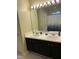 Bright bathroom featuring a double sink vanity with modern fixtures and a decorative mirror at 144 Gremar Dr, Holly Springs, NC 27540