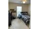 Cozy bedroom with a single bed, ceiling fan, and plenty of natural light from the window at 144 Gremar Dr, Holly Springs, NC 27540