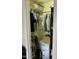 Bedroom closet with hanging clothes and additional shelving for storage at 144 Gremar Dr, Holly Springs, NC 27540