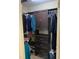 Walk-in closet with custom dark brown shelving for clothes and shoes at 144 Gremar Dr, Holly Springs, NC 27540
