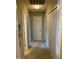 Hallway with carpeted floor and multiple doors for accessing different rooms at 144 Gremar Dr, Holly Springs, NC 27540