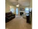 Cozy living room featuring a fireplace, ceiling fan, and comfortable seating at 144 Gremar Dr, Holly Springs, NC 27540