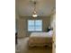 Bright bedroom with large window, ceiling fan, neutral colors, and an attached bath at 144 Gremar Dr, Holly Springs, NC 27540