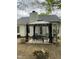 Cozy patio features an outdoor dining area with a covered gazebo and backyard grilling station at 144 Gremar Dr, Holly Springs, NC 27540