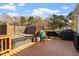 Large deck featuring a hot tub, grills, and plenty of space for outdoor entertaining at 15 Longwood Dr, Youngsville, NC 27596