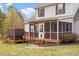 A covered porch with a hot tub is seen on the back of the house at 15 Longwood Dr, Youngsville, NC 27596