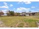 A view of the lawn, trees, and back of the house on a partially cloudy day at 15 Longwood Dr, Youngsville, NC 27596