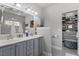 Elegant bathroom with double vanity, large mirror, and access to a walk-in closet at 15 Longwood Dr, Youngsville, NC 27596