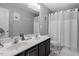 Modern bathroom with double sinks, updated fixtures, and a shower with tub at 15 Longwood Dr, Youngsville, NC 27596