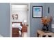 A doorway leads to the bedroom with a bed and a floral picture on the wall at 15 Longwood Dr, Youngsville, NC 27596