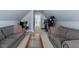 Bonus room with sofas, coffee table, a full gym, and view of a hallway leading to other rooms at 15 Longwood Dr, Youngsville, NC 27596