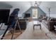 Large bonus room with vaulted ceiling, ceiling fan, and comfortable couches for relaxing at 15 Longwood Dr, Youngsville, NC 27596