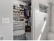 Well-organized walk-in closet with custom shelving, drawers, and adjacent walk-in shower at 15 Longwood Dr, Youngsville, NC 27596