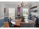 Bright dining area featuring a modern chandelier, stylish decor, and large windows at 15 Longwood Dr, Youngsville, NC 27596
