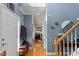 Inviting foyer with hardwood floors, blue walls, white trim, and a staircase at 15 Longwood Dr, Youngsville, NC 27596