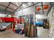 Inside the metal building, tools, equipment, and a blue car are visible at 15 Longwood Dr, Youngsville, NC 27596