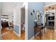 Inviting hallway showcases hardwood flooring, access to multiple rooms, and stylish decor at 15 Longwood Dr, Youngsville, NC 27596