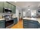 Well-equipped kitchen with stainless steel appliances, ample counter space, and wooden floors at 15 Longwood Dr, Youngsville, NC 27596