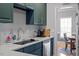 Bright kitchen featuring stainless steel appliances, light countertops, and custom cabinetry at 15 Longwood Dr, Youngsville, NC 27596