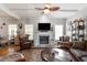 Spacious living room featuring a fireplace, large windows, and comfortable seating at 15 Longwood Dr, Youngsville, NC 27596