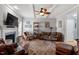 Cozy living room features a fireplace, ceiling fan, and an area rug over the hardwood floors at 15 Longwood Dr, Youngsville, NC 27596