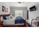 A large bed with a navy-blue quilt and chair is seen inside the main bedroom at 15 Longwood Dr, Youngsville, NC 27596