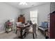 Bright office with large window, neutral paint, ceiling fan, desk, and workspace at 15 Longwood Dr, Youngsville, NC 27596