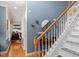 Staircase with white banister and gray-blue walls, along with a dining room at 15 Longwood Dr, Youngsville, NC 27596