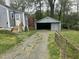 Backyard featuring a detached garage and a house with gray siding at 1609 Evergreen St, Durham, NC 27703