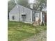 Gray home featuring a white door, fenced yard, and a small porch at 1609 Evergreen St, Durham, NC 27703