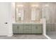 Modern bathroom featuring a double vanity, framed mirrors, tiled walls, and glass-enclosed shower at 1621 Bruce Circle, Raleigh, NC 27604