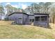 Modern home exterior featuring a screened-in porch and a fenced backyard at 1621 Bruce Circle, Raleigh, NC 27604