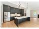 Contemporary kitchen with dark cabinets, stainless steel appliances, and a large center island at 1621 Bruce Circle, Raleigh, NC 27604