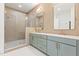 Modern bathroom with double vanity, decorative tile, and glass shower at 1625 Bruce Circle, Raleigh, NC 27604