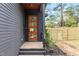 Side view of a stylish gray home with a wood-framed glass door and a newly installed wooden fence at 1625 Bruce Circle, Raleigh, NC 27604