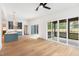 Bright and open concept living space with hardwood floors, modern kitchen, and sliding doors to a screened porch at 1625 Bruce Circle, Raleigh, NC 27604