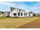 Expansive backyard view showcasing the home's exterior, a neatly kept lawn, and fencing at 1629 Montvale Grant Way, Cary, NC 27519