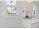 Bright bathroom featuring a modern vanity with a view of the landscaping outside at 1629 Montvale Grant Way, Cary, NC 27519