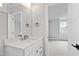 Bright bathroom featuring a modern vanity with white countertop and a large mirror with views to the Primary bedroom at 1629 Montvale Grant Way, Cary, NC 27519