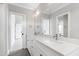 Bright bathroom with a double vanity, framed mirrors, and modern fixtures at 1629 Montvale Grant Way, Cary, NC 27519