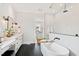 Luxurious bathroom featuring a modern shower, a soaking tub, and double vanities at 1629 Montvale Grant Way, Cary, NC 27519