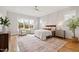 Spacious bedroom featuring a ceiling fan, a large window, and hardwood floors at 1629 Montvale Grant Way, Cary, NC 27519