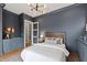 Bedroom with dark blue walls, recessed lighting, and a decorative light fixture at 1629 Montvale Grant Way, Cary, NC 27519