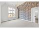 Elegant bedroom features stylish wallpaper and a modern chandelier for a touch of sophistication at 1629 Montvale Grant Way, Cary, NC 27519