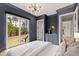 Comfortable bedroom with dark blue walls, sliding glass doors, and hardwood floors at 1629 Montvale Grant Way, Cary, NC 27519